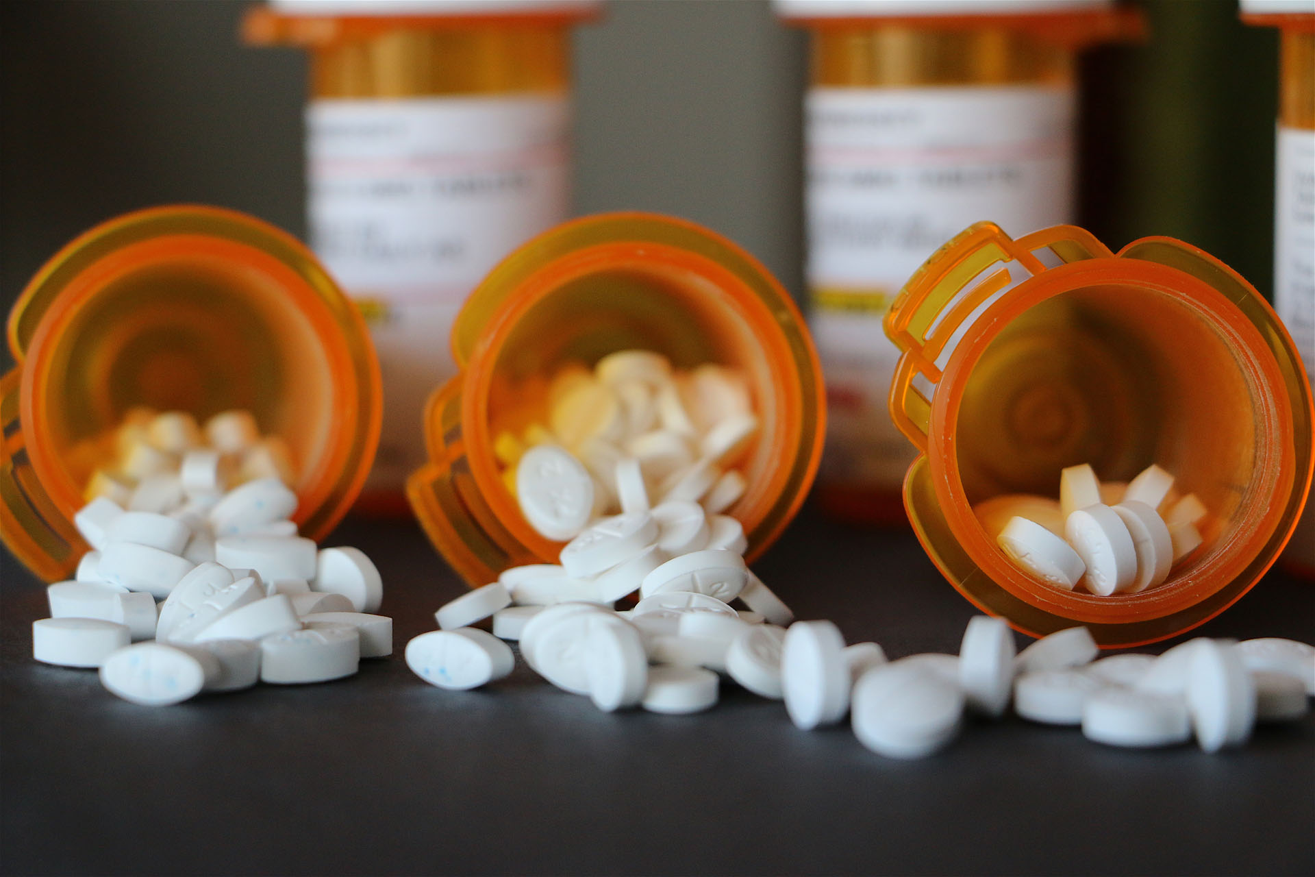 Three bottles with different prescription medications in them. 