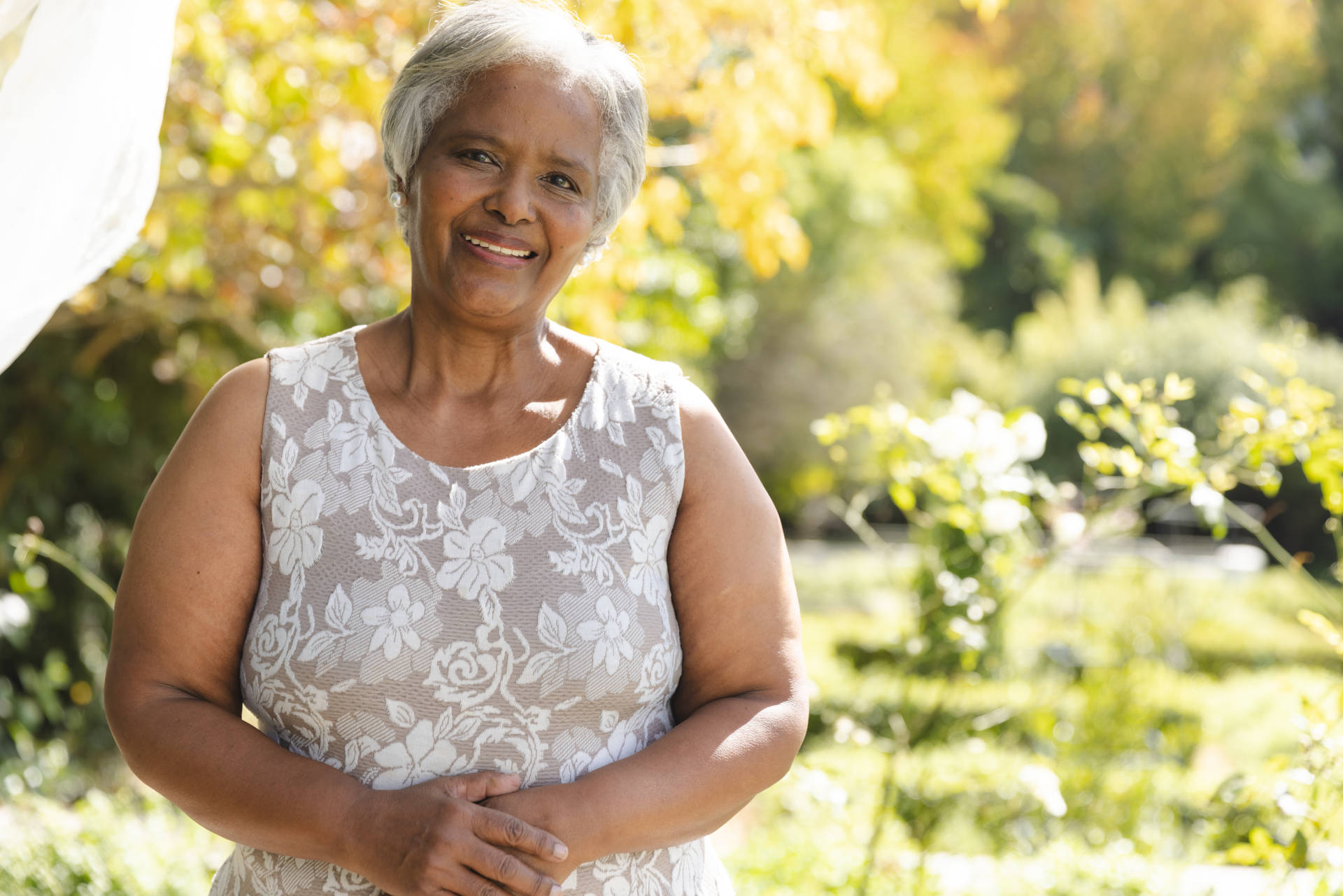 A smiling woman holding her stomach. 