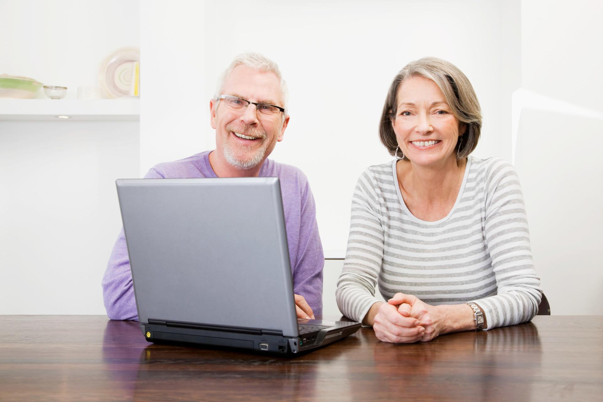 A senior couple looking at a laptop screen